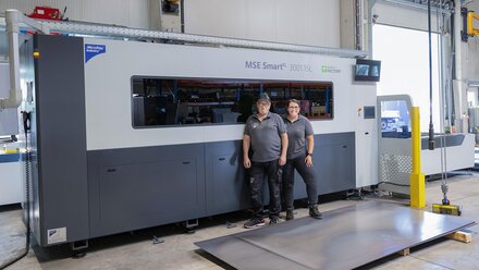 Happy managing directors in front of the new laser cutting system